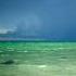 Calm Ocean And Split Sky Sunlight And Rain