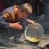 Palestinian Child Gathers Pasta Off The Ground At Community Kitchen