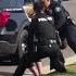 Police Officers Stop Fellow Officer Punching Handcuffed Woman During Arrest