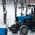 The City Is Snowed In A Tractor With A Brush Cleans The Snow At Full Throttle